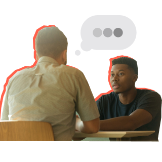 Man and young man sitting across from each other talking