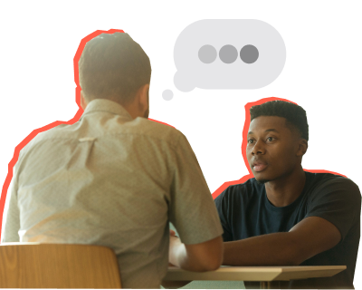 Man and young man sitting across from each other talking