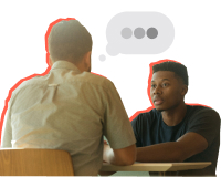 Man and young man sitting across from each other talking